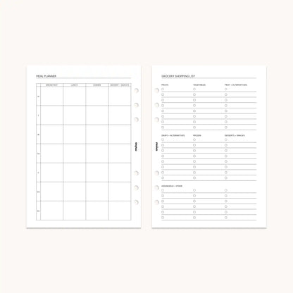 Open planner displaying a meal planner page alongside a grocery shopping list, with clear sections for categorized items such as fruits, vegetables, and pantry essentials.